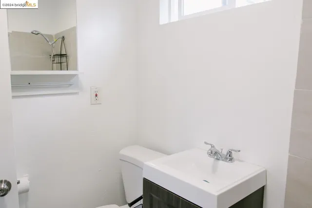 a bathroom with a sink vanity and a bathtub