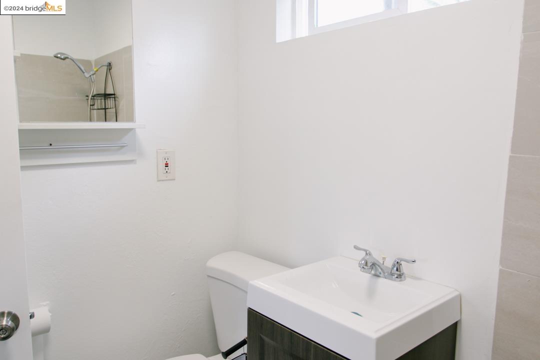 1173 12th Street Oakland, CA 94607 - Photo 12 of 21 a bathroom with a sink and a toilet
