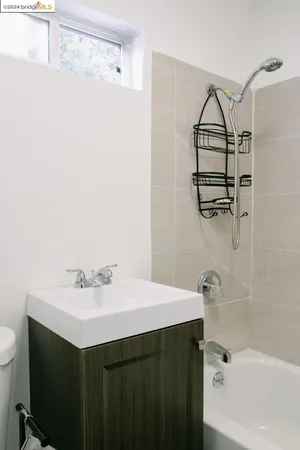 a bathroom with a bathtub sink vanity and toilet