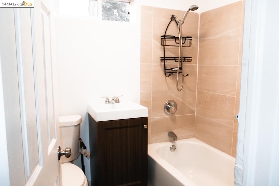1173 12th Street Oakland, CA 94607 - Photo 14 of 21 a bathroom with a bathtub sink vanity and toilet
