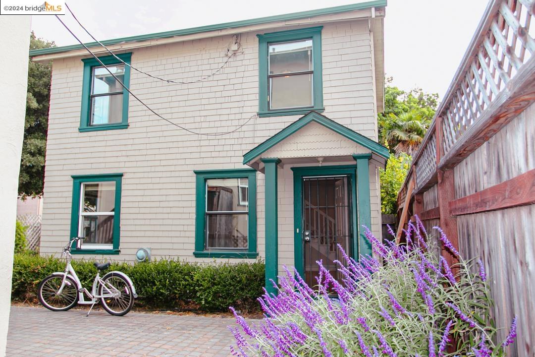 1173 12th Street Oakland, CA 94607 - Photo 2 of 21 a front view of a house with a yard