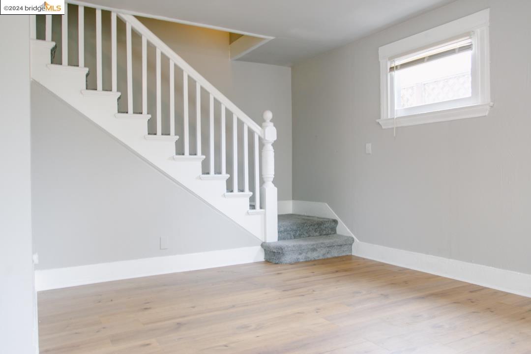 1173 12th Street Oakland, CA 94607 - Photo 10 of 21 a view of staircase with wooden floor and white walls