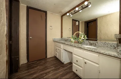 a bathroom with a double vanity sink and a mirror