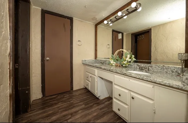 a bathroom with a double vanity sink and a mirror