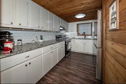 a kitchen with sink cabinets and window