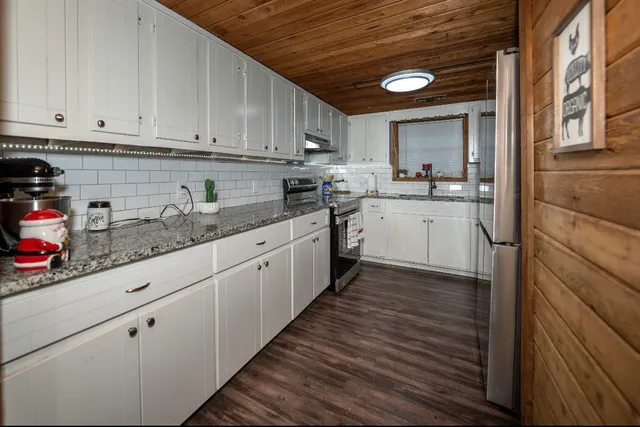 a kitchen with sink cabinets and window