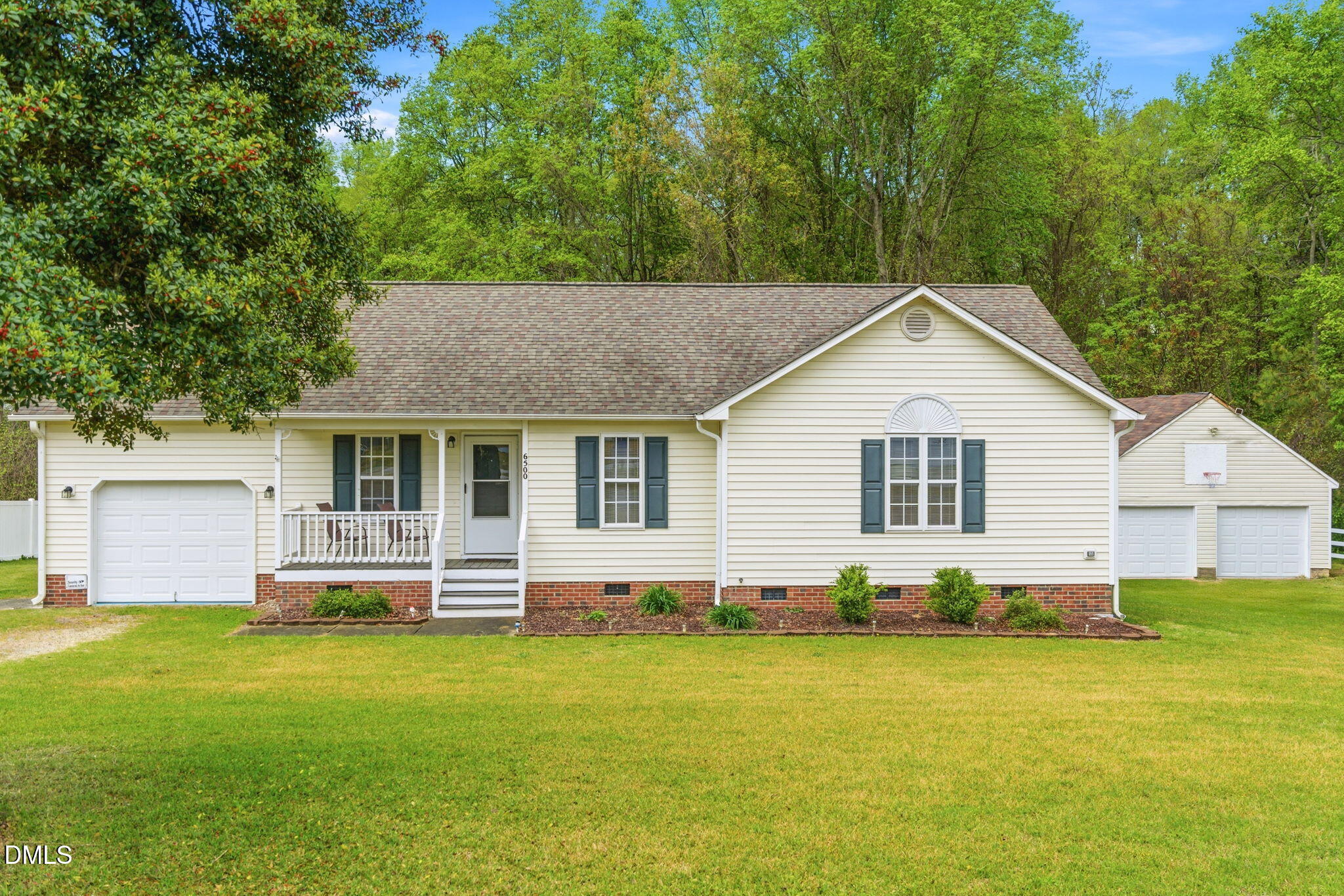 a front view of house with yard and green space