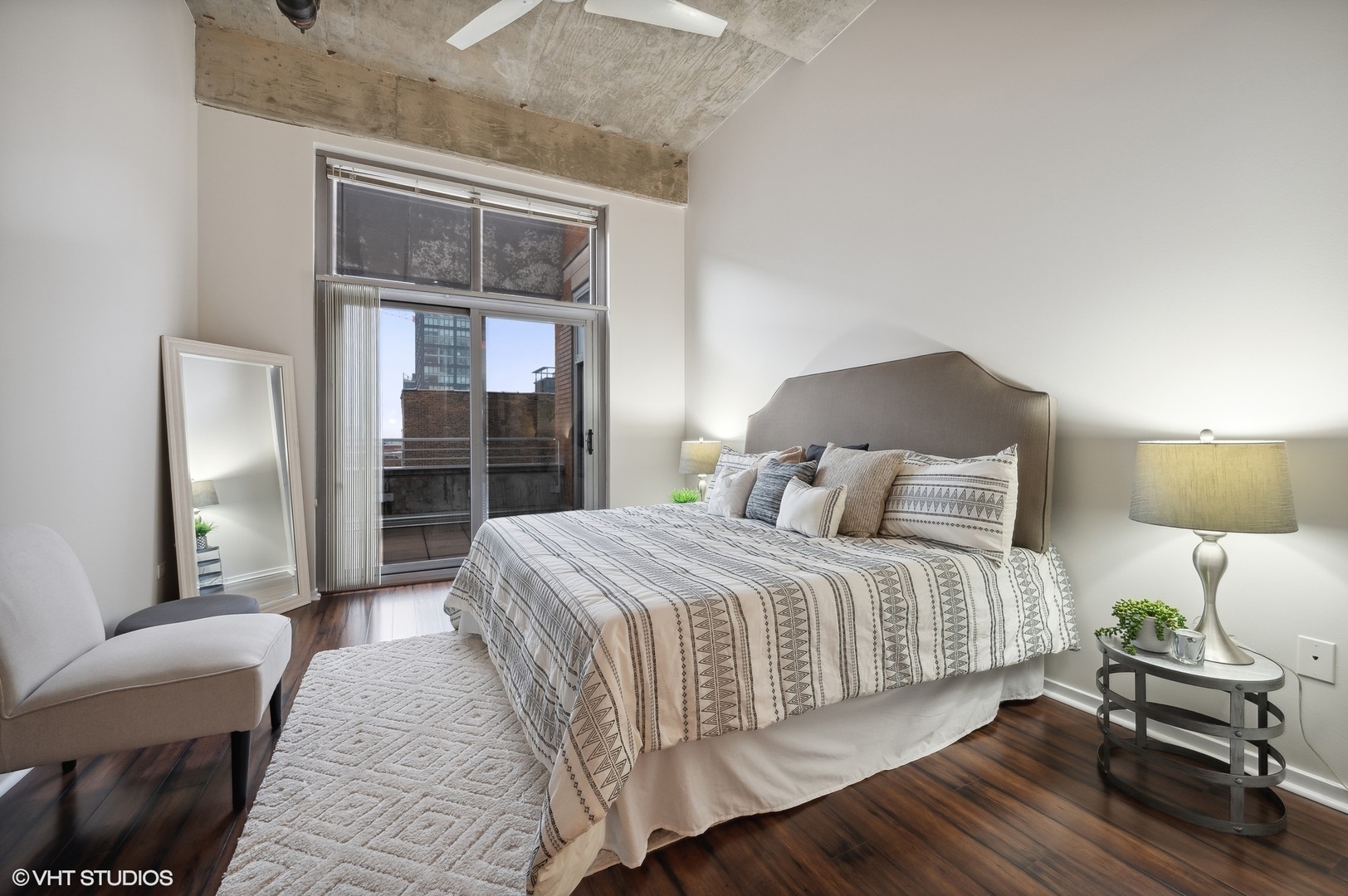 933 West Van Buren Street, Unit 917 Chicago, IL 60607 - Photo 14 of 24 a bedroom with a bed and wooden floor