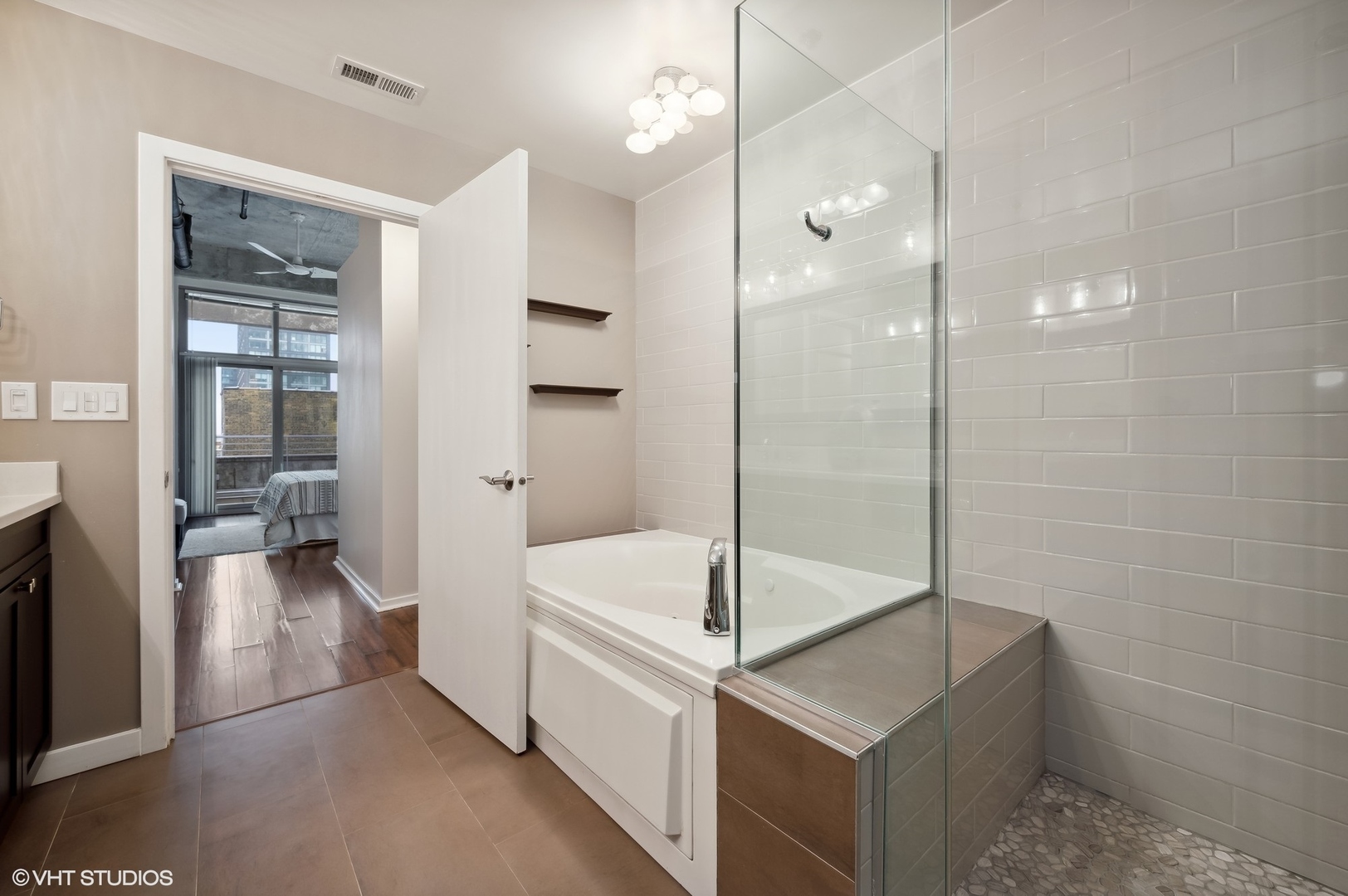 933 West Van Buren Street, Unit 917 Chicago, IL 60607 - Photo 17 of 24 a bathroom with a tub and shower