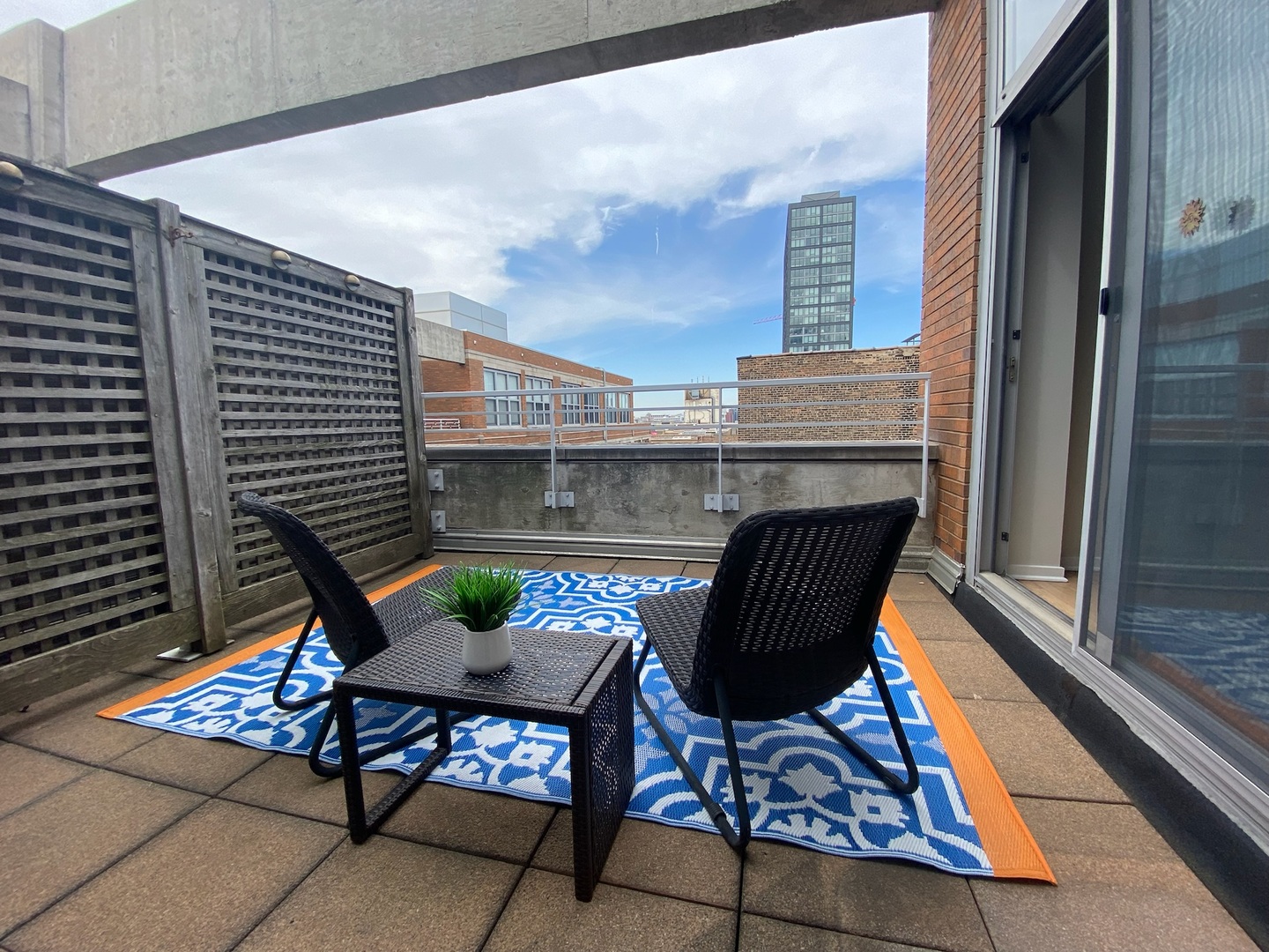 933 West Van Buren Street, Unit 917 Chicago, IL 60607 - Photo 20 of 24 a patio with patio couch and table