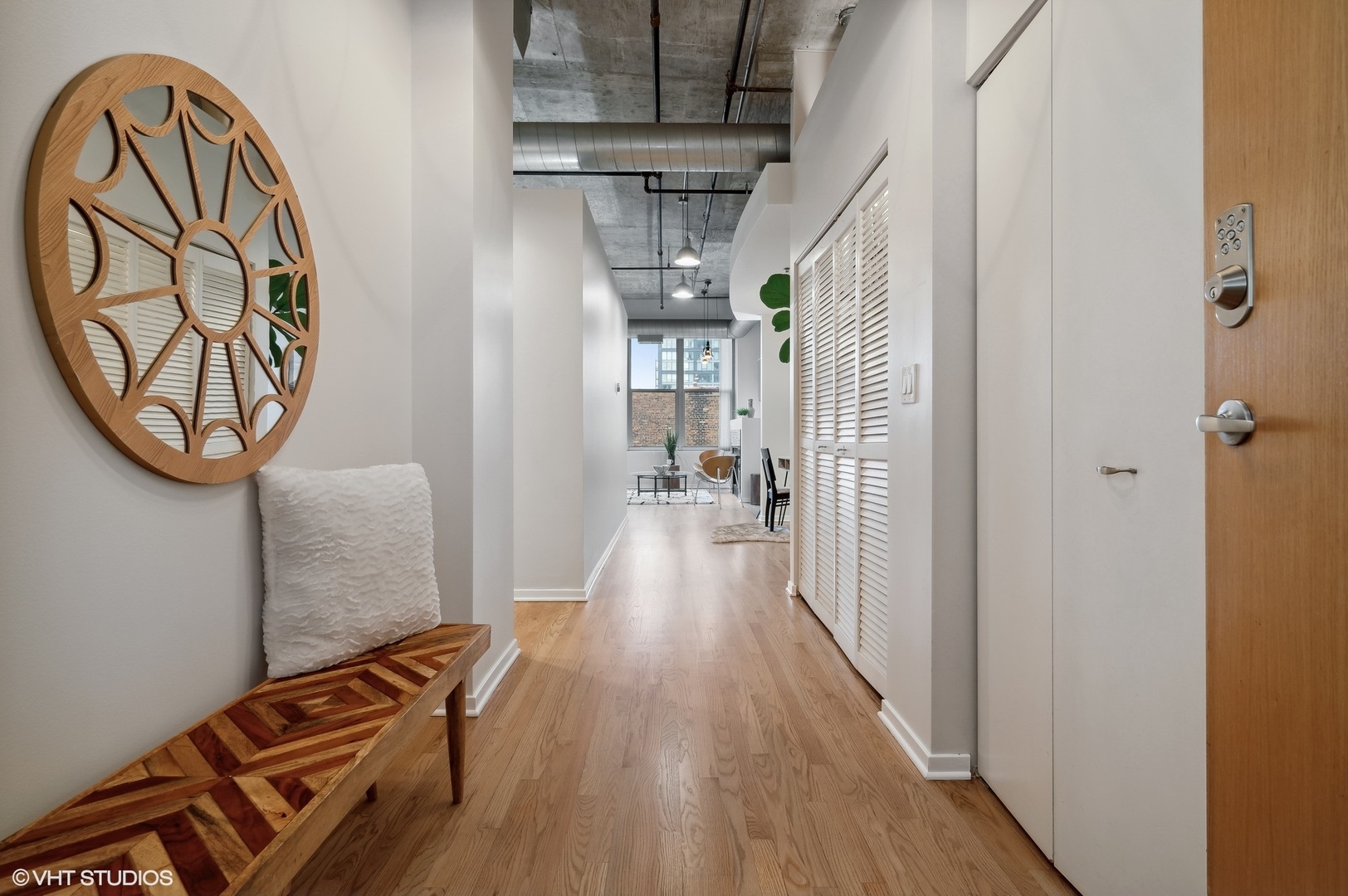 933 West Van Buren Street, Unit 917 Chicago, IL 60607 - Photo 2 of 24 a view of a hallway with wooden floor