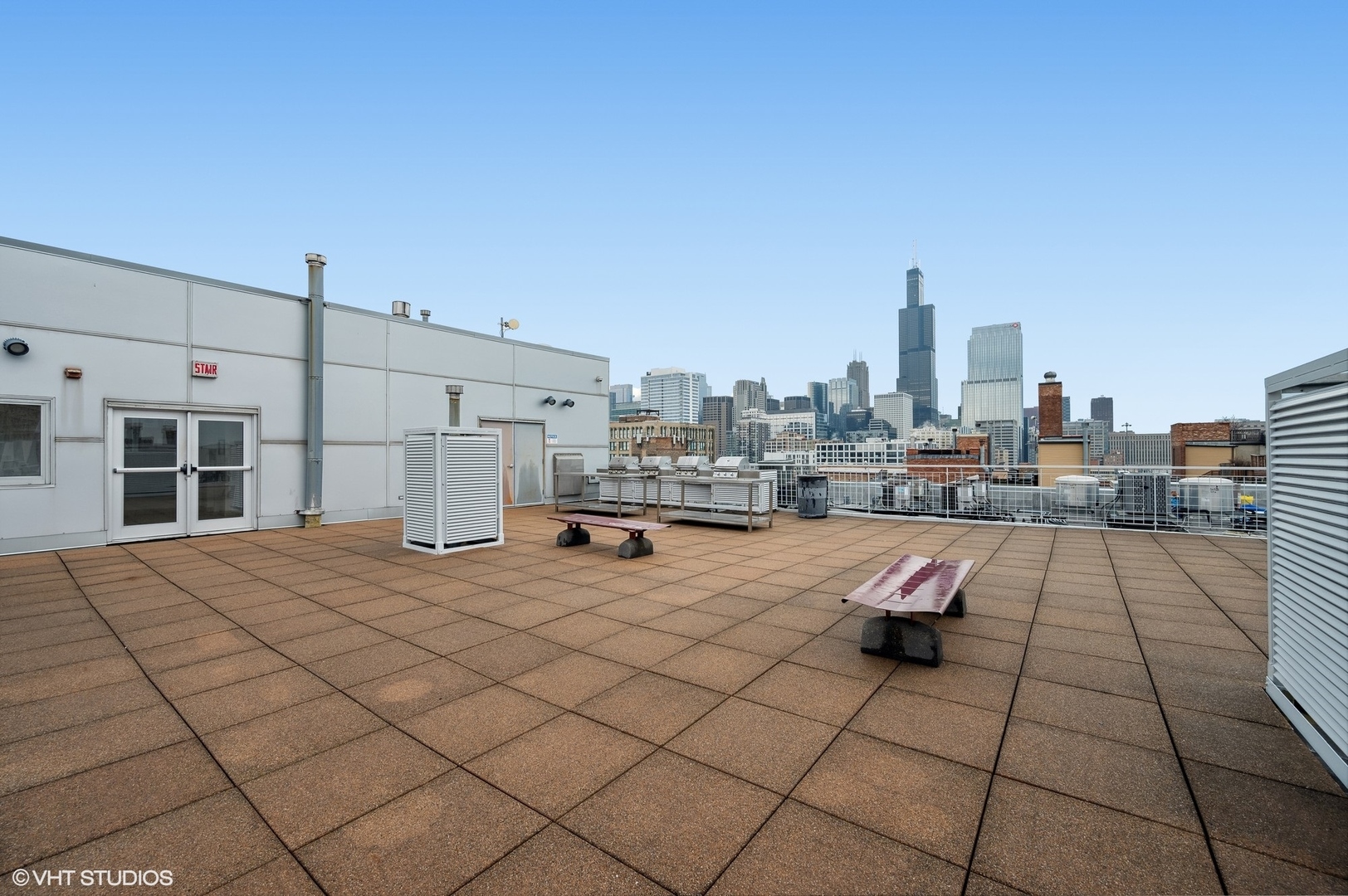 933 West Van Buren Street, Unit 917 Chicago, IL 60607 - Photo 21 of 24 a view of roof deck with dining table and chair