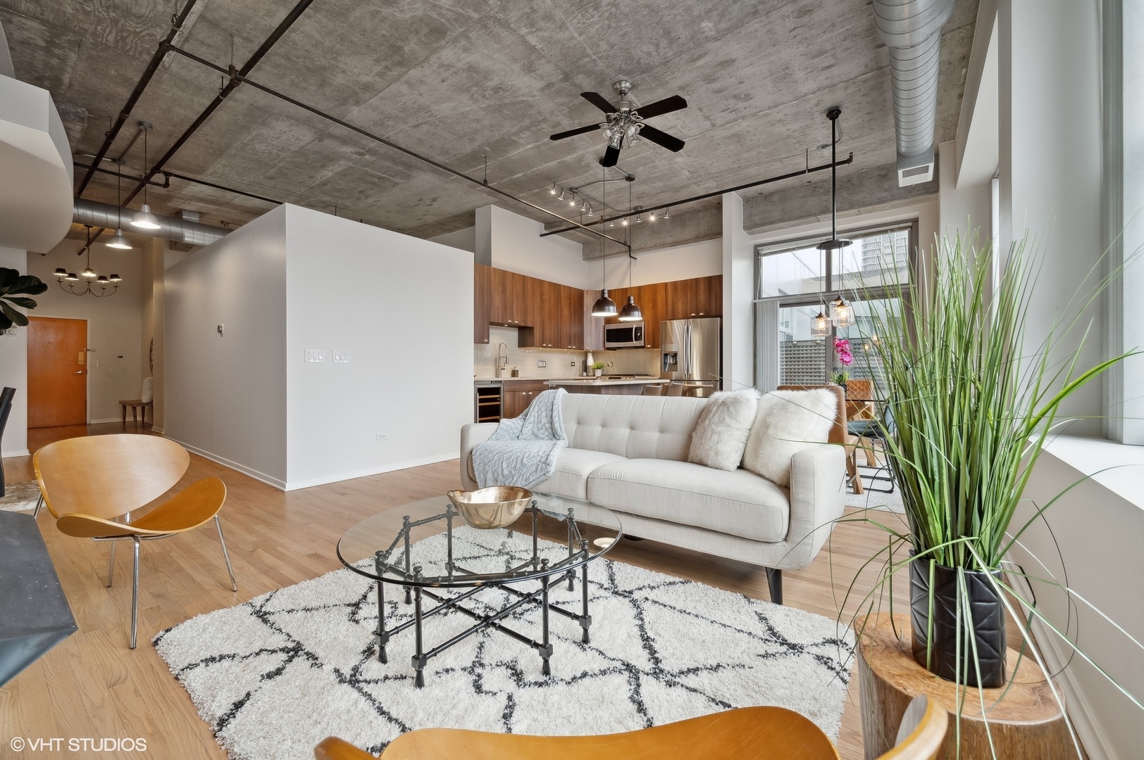 933 West Van Buren Street, Unit 917 Chicago, IL 60607 - Photo 4 of 24 a living room with furniture and a large window