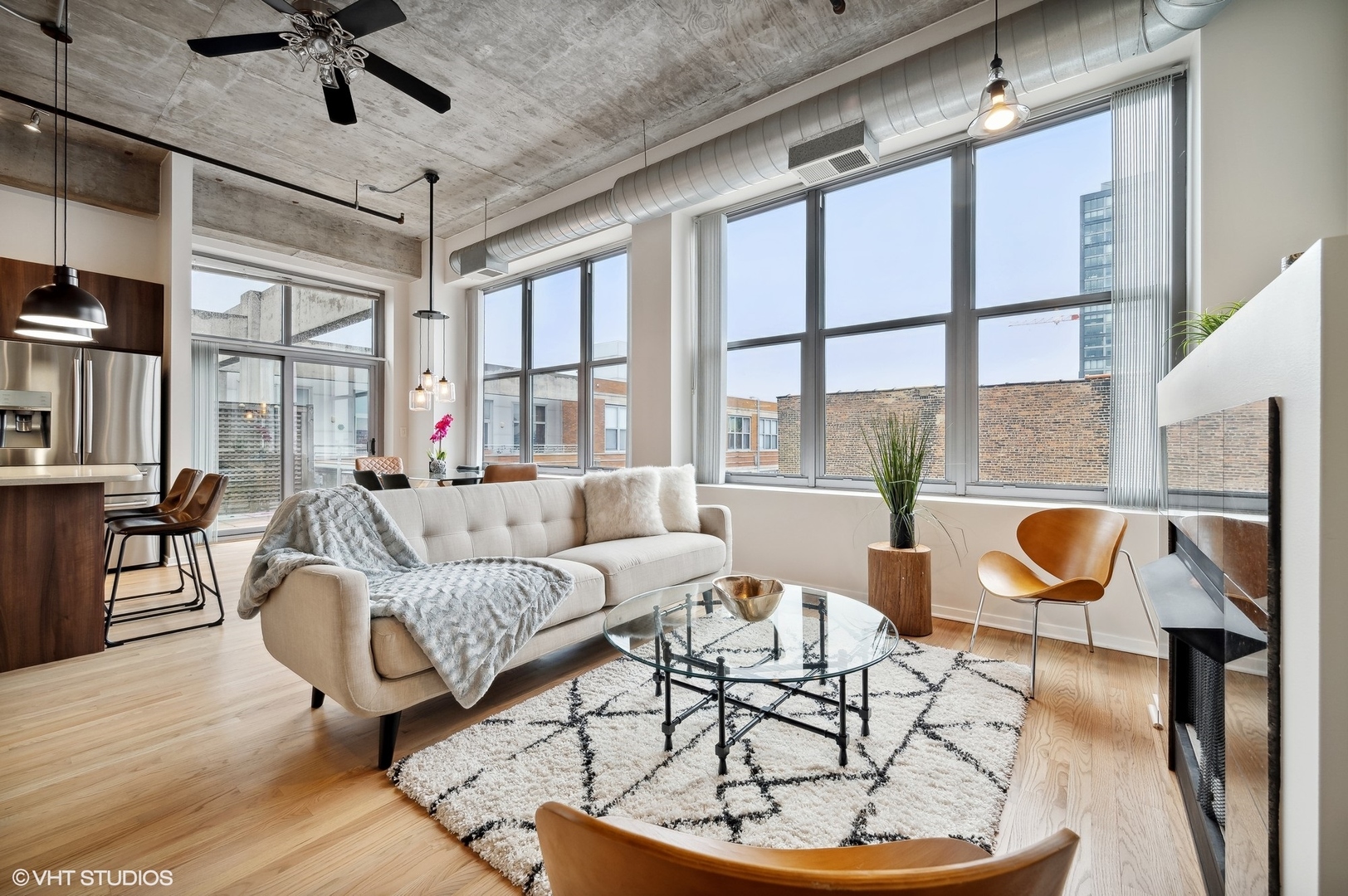 933 West Van Buren Street, Unit 917 Chicago, IL 60607 - Photo 6 of 24 a living room with furniture and a floor to ceiling window