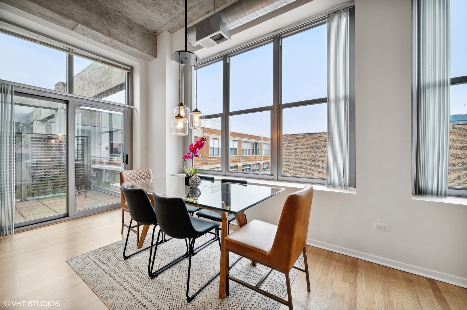 933 West Van Buren Street, Unit 917 Chicago, IL 60607 - Photo 7 of 24 a dining room with furniture and wooden floor