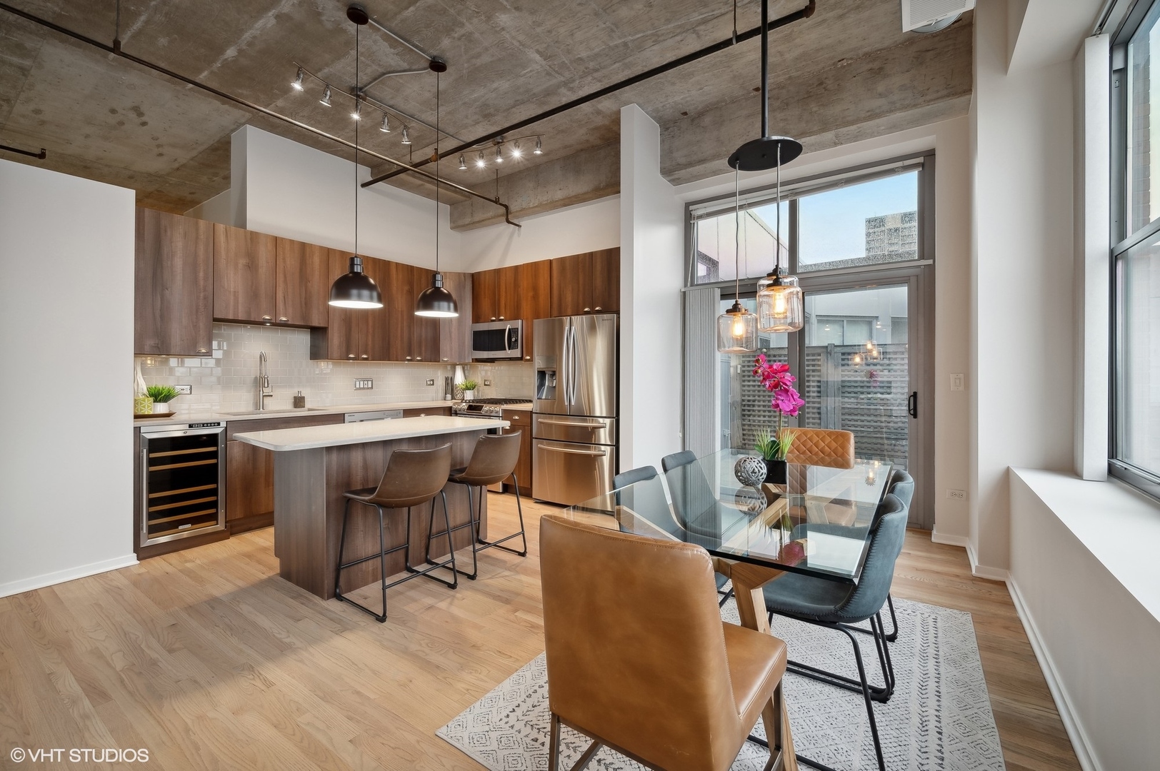 933 West Van Buren Street, Unit 917 Chicago, IL 60607 - Photo 8 of 24 a kitchen with stainless steel appliances kitchen island granite countertop a sink and cabinets