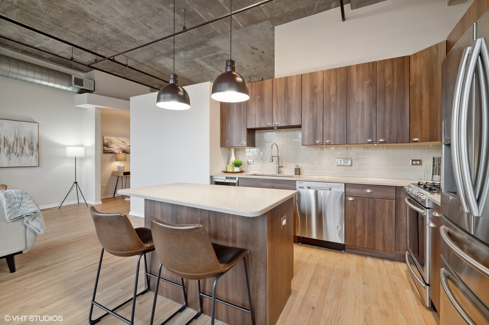 933 West Van Buren Street, Unit 917 Chicago, IL 60607 - Photo 10 of 24 a kitchen with a table chairs refrigerator and cabinets