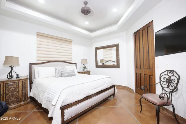 a bedroom with a bed and a chandelier