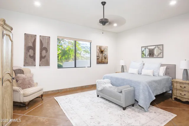 a spacious bedroom with a bed and a couch