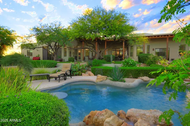 a view of a chair and table in backyard of the house
