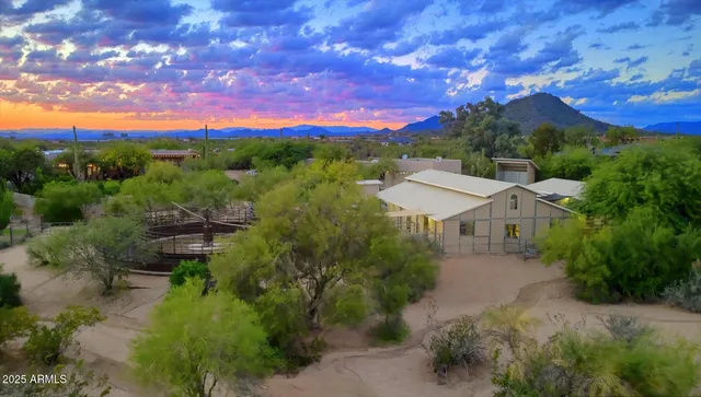 a view of a patio with couches and table and chairs with wooden fence