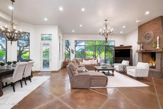 a living room with fireplace furniture and a large window