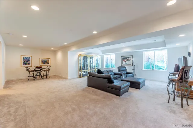 a living room with furniture and a table with projector screen