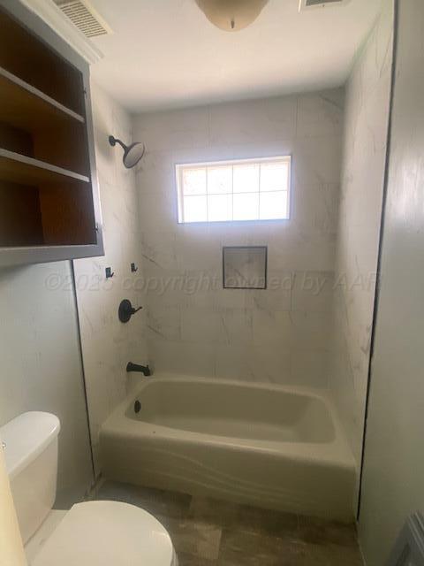 8101 Sheldon Road Amarillo, TX 79119 - Photo 11 of 12 a bathroom with a toilet and a bathtub