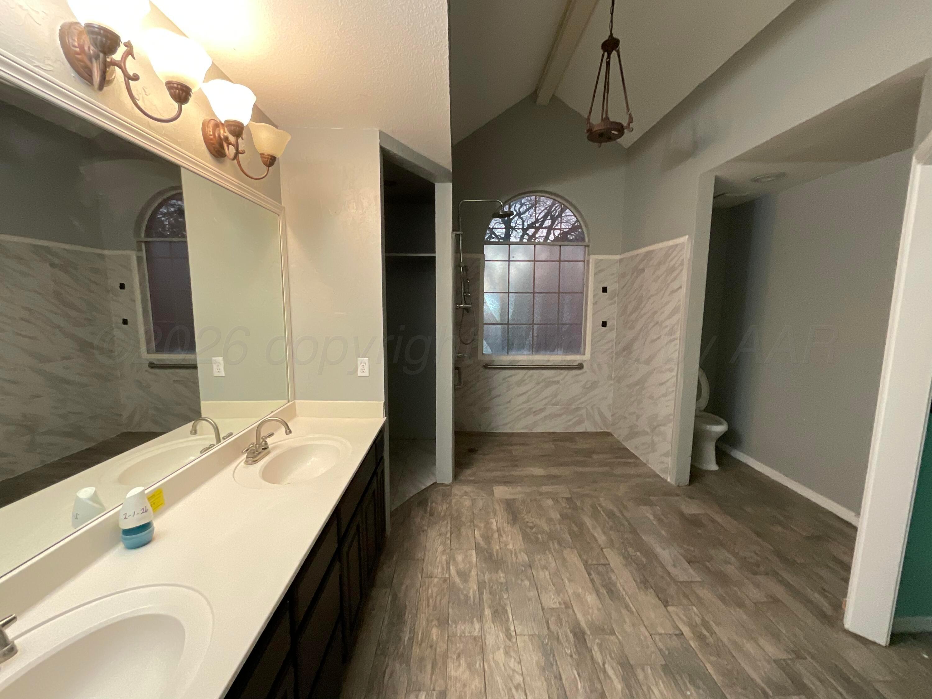 8101 Sheldon Road Amarillo, TX 79119 - Photo 12 of 20 a spacious bathroom with a sink and a mirror