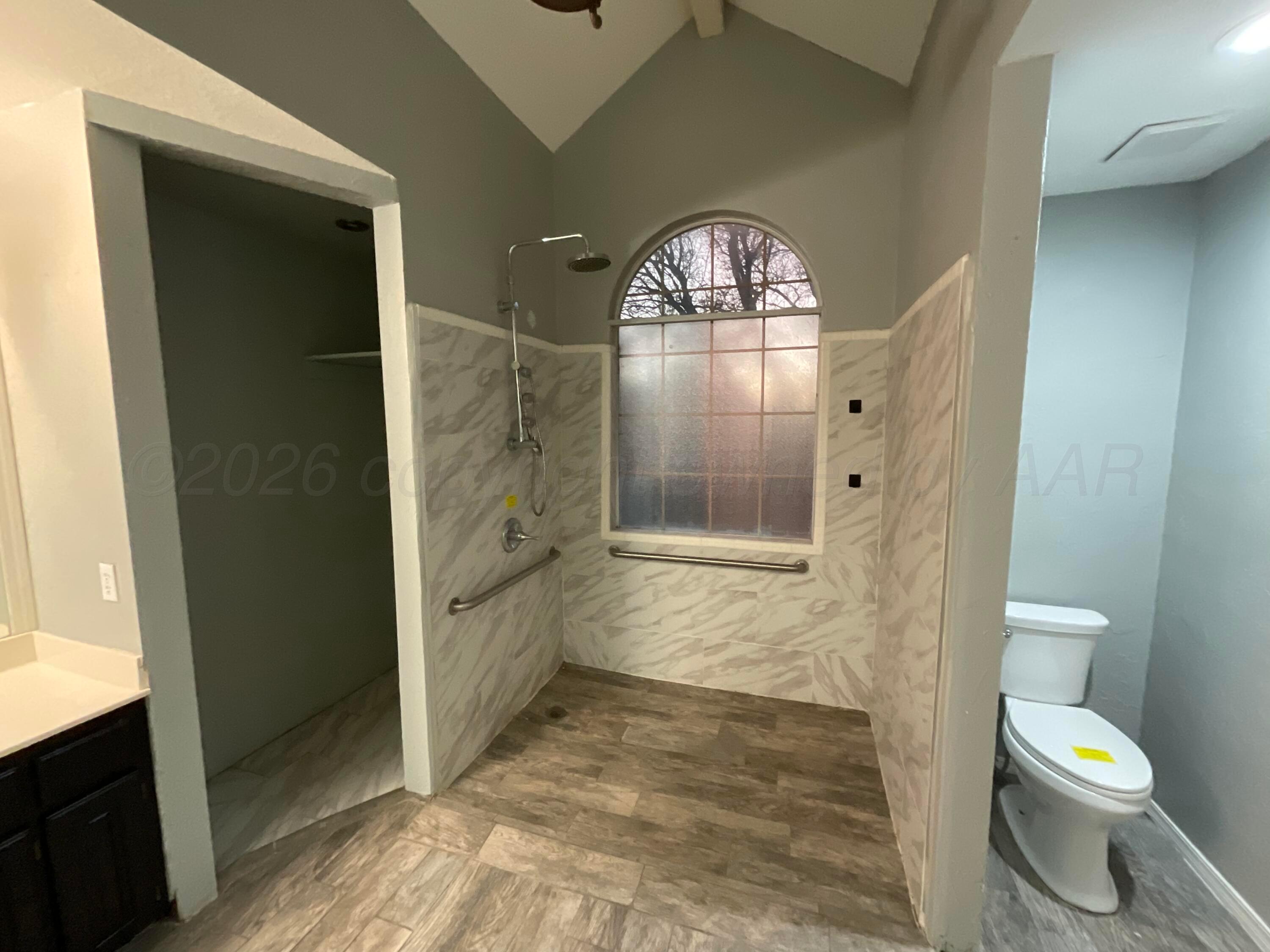 8101 Sheldon Road Amarillo, TX 79119 - Photo 13 of 20 a bathroom with a granite countertop toilet a sink and a shower