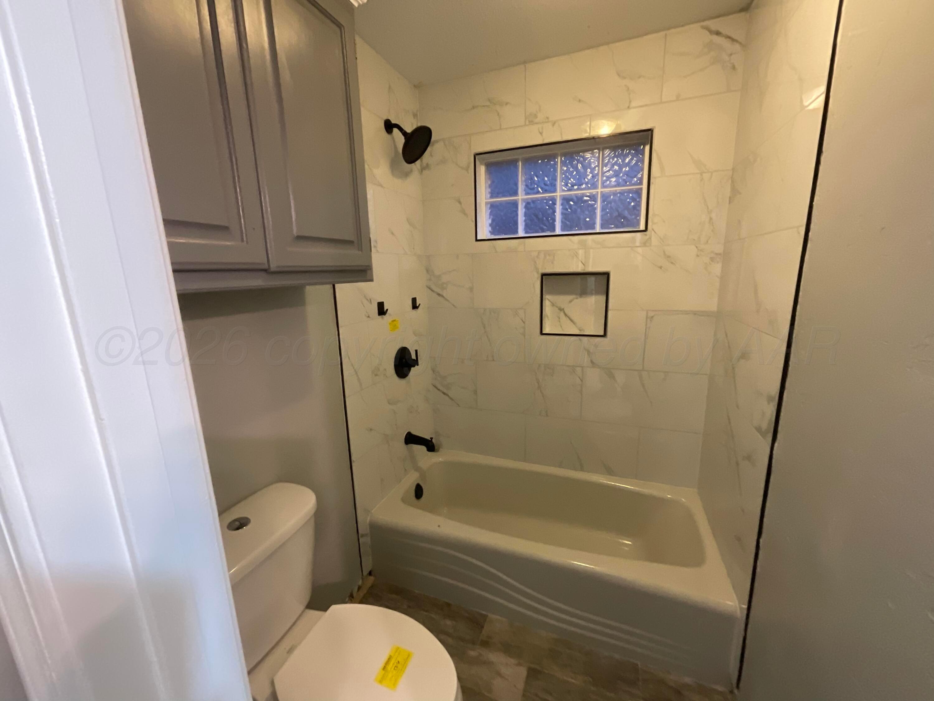 8101 Sheldon Road Amarillo, TX 79119 - Photo 16 of 20 a bathroom with a tub and sink