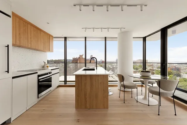 a kitchen with stainless steel appliances a stove a sink and a refrigerator