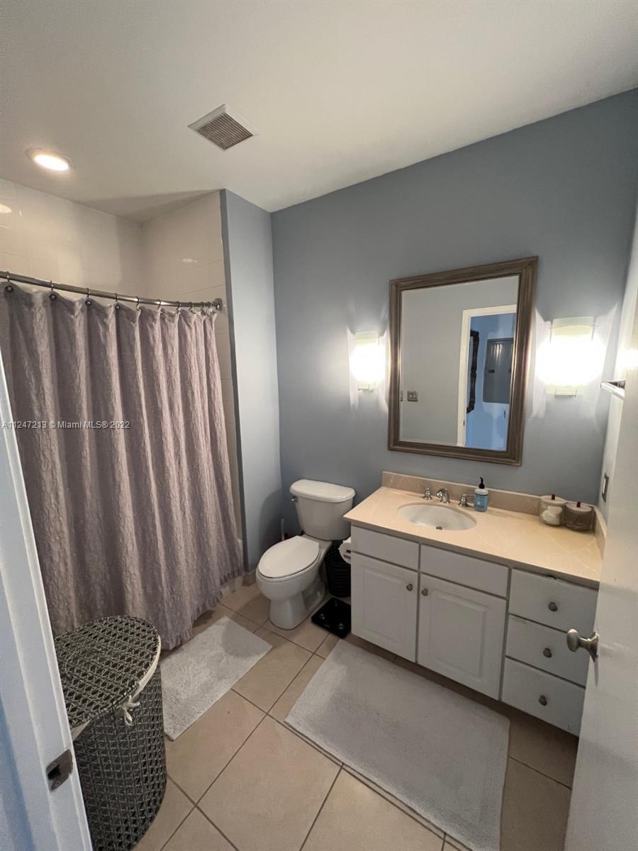2001 Biscayne Boulevard, Unit 2414 Miami, FL 33137 - Photo 8 of 8 a bathroom with a double vanity sink and mirror