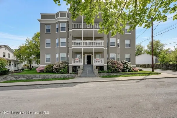 a view of a building with a yard