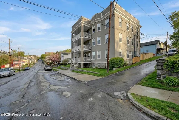 a view of a street with a building in the background