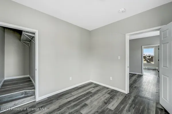 a view of walk in closet with empty racks