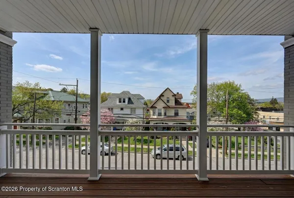 a view of a balcony with wooden floor