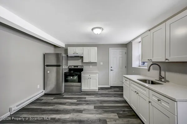a bathroom with a toilet sink vanity and mirror