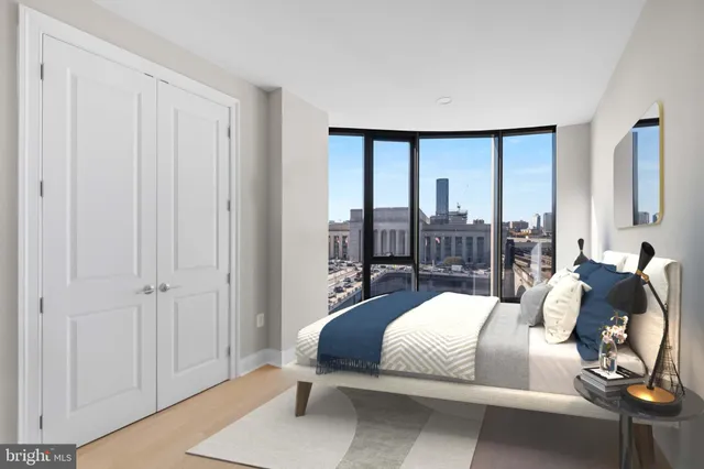 a bedroom with a large bed and a large window