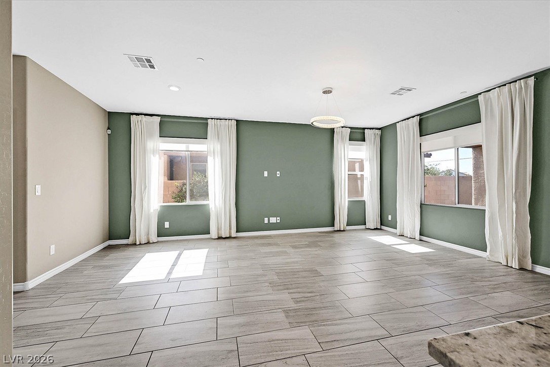 1106 Langston Ranch Avenue Henderson, NV 89002 - Photo 5 of 36 Natural light illuminates this spacious living area with resilient tile flooring.