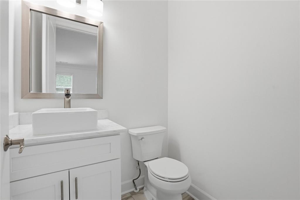 2415 West Rugby Avenue Atlanta, GA 30337 - Photo 35 of 40 a bathroom with a toilet sink and mirror
