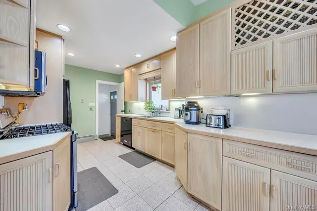 a kitchen with granite countertop a sink and cabinets