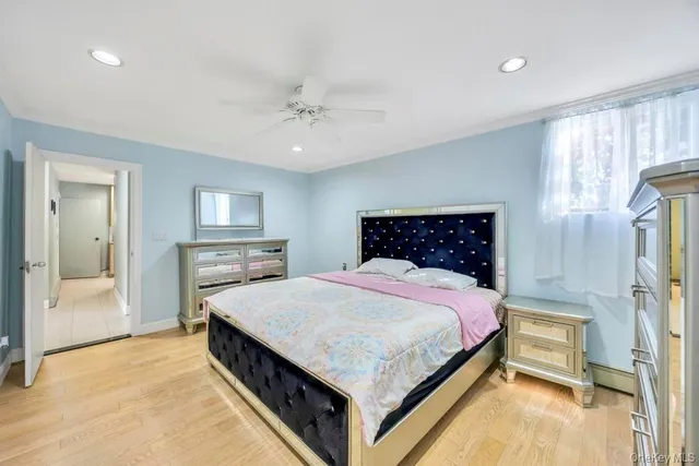 a spacious bedroom with a bed and a chandelier