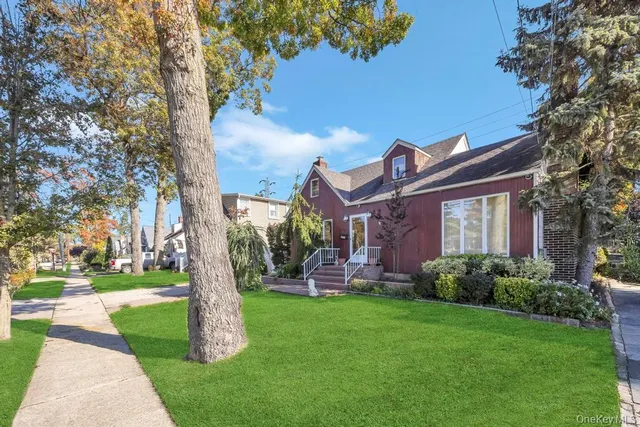 a front view of house with yard and green space