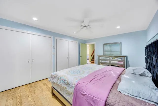 a spacious bedroom with a large bed and a chandelier