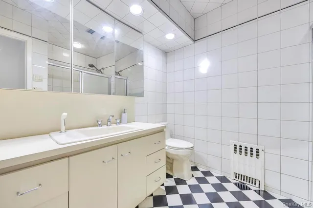 a bathroom with a sink a toilet and a shower