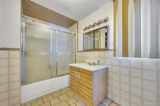 a bathroom with a sink a mirror and a shower