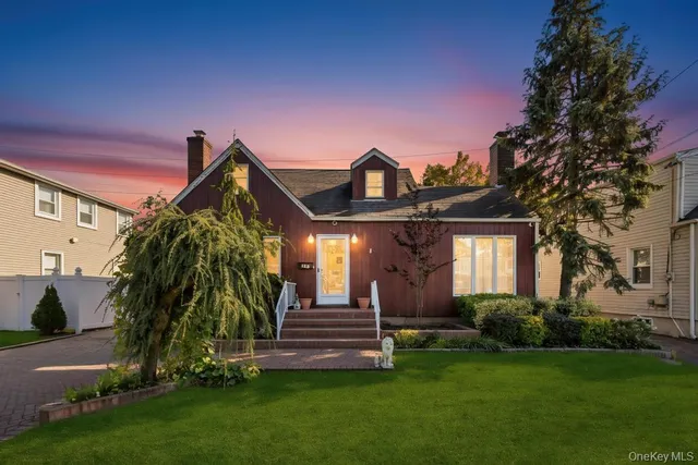 a front view of a house with a garden