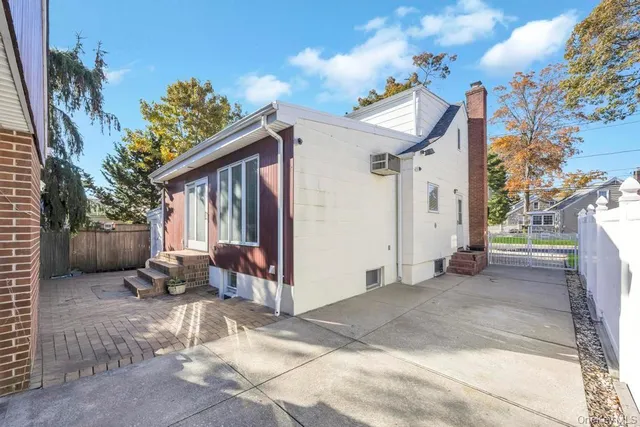 a view of a patio with table and chairs with wooden floor and fence