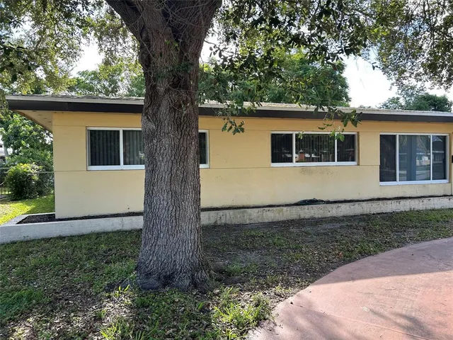 a view of house with backyard